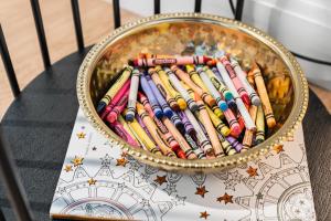 a bowl of crayons sitting on top of a table at Family Friendly Boston Suite in Cambridge