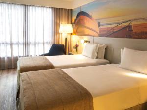 Postel nebo postele na pokoji v ubytování Novotel Florianopolis