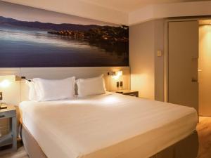 Postel nebo postele na pokoji v ubytování Novotel Florianopolis