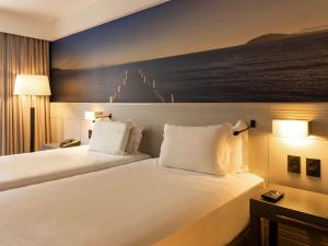 Postel nebo postele na pokoji v ubytování Novotel Florianopolis