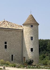 a large stone building with a cross on top at Manoir - Domaine Lassalle Saint-créac in Saint-Créac +32 photos