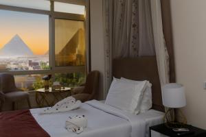Postelja oz. postelje v sobi nastanitve Pyramids Palace INN