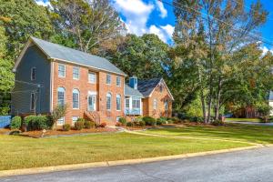 a large brick house with a yard at about 30 Mi to Atlanta - The Wellness Manor with Deck! in Snellville