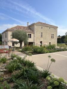a large stone building in front of a street at Gîte L'Etable - Domaine Lassalle Saint-créac in Saint-Créac +33 photos