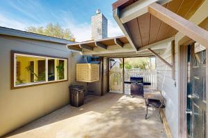 a patio with a window and a table and a chair at Gold Country Getaway in Jamestown