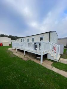 a mobile home with a porch and a deck at 3 Bedroom - Stunning Caravan in Coastal Eyemouth in Eyemouth