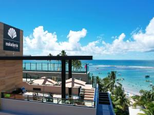 a view of the beach from the balcony of a resort at Tekatetu Hotels e Flats - Makadamia Porto de Galinhas in Porto De Galinhas