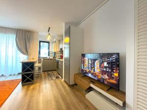a living room with a flat screen tv on a wall at Lumial Mountain Nest in Braşov
