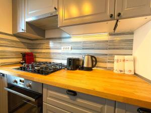a kitchen counter top with a stove top oven at Lumial Mountain Nest in Braşov