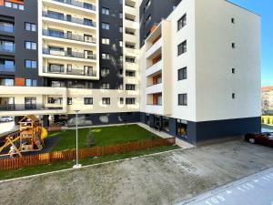an empty parking lot in front of a building at Lumial Mountain Nest in Braşov