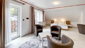 a hotel room with a bed and chairs and a window at Smart Resorts B&B1 BB1 135 in Winterberg