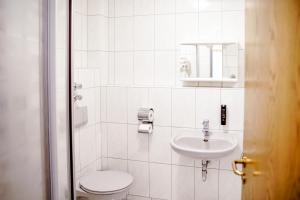 a white bathroom with a toilet and a sink at Smart Resorts B&B2 BB2 311 in Winterberg +42 photos