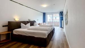 a bedroom with two beds and a large window at Smart Resorts B&B2 BB2 311 in Winterberg