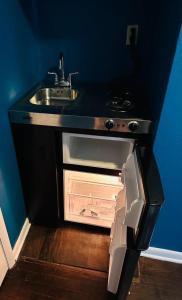 a kitchen with a sink and an open oven at A place like nowhere else in Lawton +87 photos