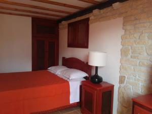 a bedroom with a bed and a lamp on a table at Apartments Picasso Komiza in Komiža