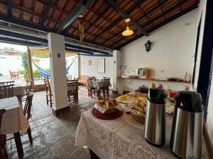 a kitchen and dining room with a table with bread on it at Pousada Athena in Palmeiras