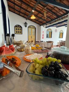 a table with a bunch of food on it at Pousada Athena in Palmeiras +47 photos