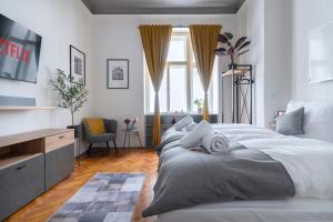 a bedroom with a large white bed and a window at 3 Bedroom - Central Superior-Flat 115m2 in Prague
