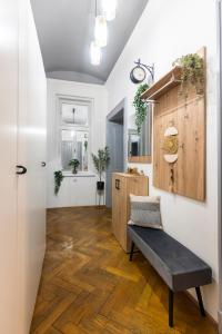 a living room with a bench on a wooden floor at 3 Bedroom - Central Superior-Flat 115m2 in Prague