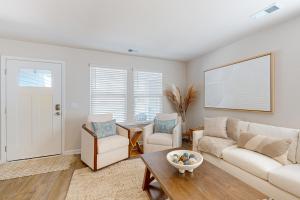 a living room with a couch and chairs and a table at Coastal Pines in Ocean Isle Beach