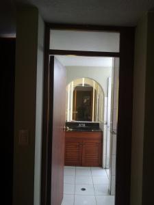 a hallway with a bathroom with a sink and a mirror at La Casa Junto Al Rio in Arequipa +45 photos