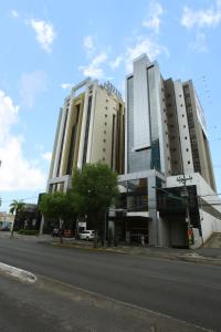 two tall buildings on the side of a street at Paiaguas Palace Hotel in Cuiabá