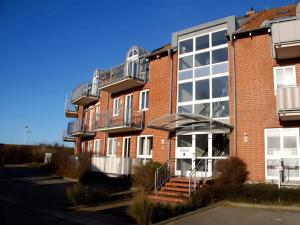a large brick building with stairs and a balcony at Comfortable holiday home in nature in Schönberg