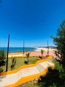 a yellow steps leading down to the beach at Hostel dos Gring0s in Maricá +19 photos