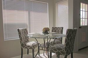 a dining room with a table and four chairs at Cozy house near I-10 with pool heater, hot tub, BBQ in Goodyear