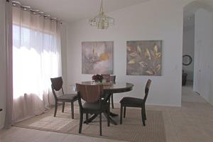 a dining room with a table and chairs at Cozy house near I-10 with pool heater, hot tub, BBQ in Goodyear