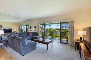 a living room with a couch and a tv at Alii Kai II 8H in Princeville