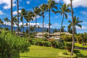 a park with palm trees and a building at Alii Kai II 8H in Princeville