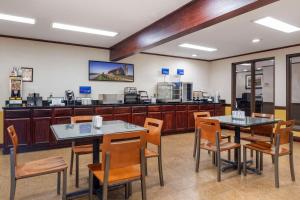 a restaurant with two tables and chairs and a counter at Best Western Campbellsville Inn in Campbellsville