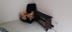 a wooden bench sitting against a white wall at 11Suites casa Suite #6 in Caraguatatuba