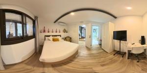 a bedroom with a large white bed and a desk at Camins del Priorat Ermita sant Pau in Masroig