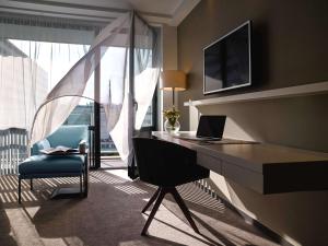a room with a desk with a laptop and a chair at Pullman Paris Tour Eiffel in Paris