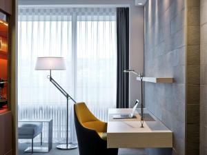 a room with a desk with a laptop and a chair at Pullman Paris Tour Eiffel in Paris