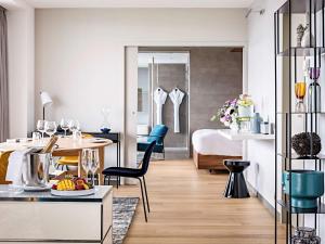 a living room and a bedroom with a table and chairs at Pullman Paris Tour Eiffel in Paris