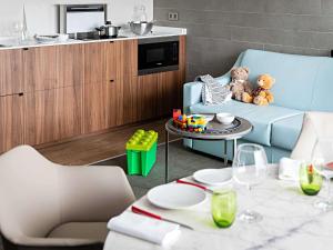 a living room with two teddy bears sitting on a blue couch at Pullman Paris Tour Eiffel in Paris