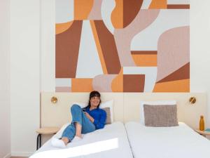 Postel nebo postele na pokoji v ubytování Aparthotel Adagio Access Paris Asnières