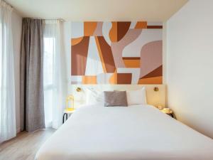 Postel nebo postele na pokoji v ubytování Aparthotel Adagio Access Paris Asnières