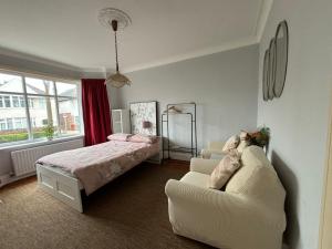 a bedroom with a bed and a couch and a bed at Winton house home stay in Bournemouth