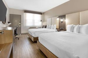 a hotel room with two beds and a sink at Best Western Marina State Beach in Marina +20 photos