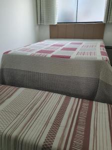 Ένα ή περισσότερα κρεβάτια σε δωμάτιο στο Quarto & Conforto