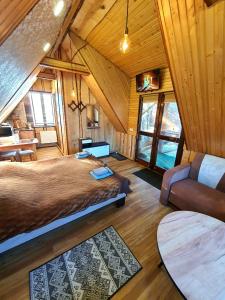 a bedroom with a bed and a couch in a room at Lavanda cottage in Verkhovyna