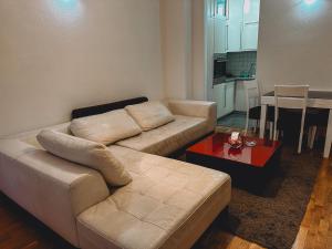 a living room with a couch and a table at Meus Residence in Mostar