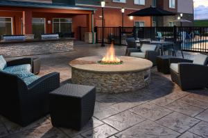 a fire pit in a patio with chairs and tables at Residence Inn by Marriott Houston NASA/Clear Lake in Friendswood