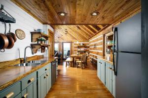 a kitchen with a refrigerator and a table in it at Cliffside Family Retreat with View in Pine Ridge