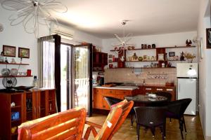 a kitchen with a table and chairs and a refrigerator at Apartment Ela in Rogač +30 photos