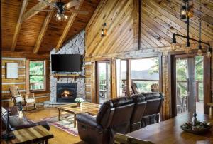 a living room with a table and a fireplace at Cliffside Family Retreat with View in Pine Ridge